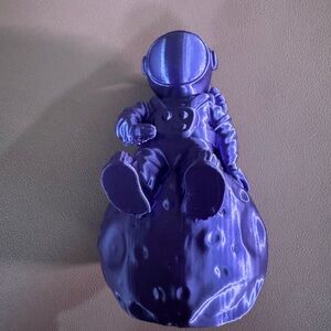 Metallic Purple Astronaut Figurine on Moon Base